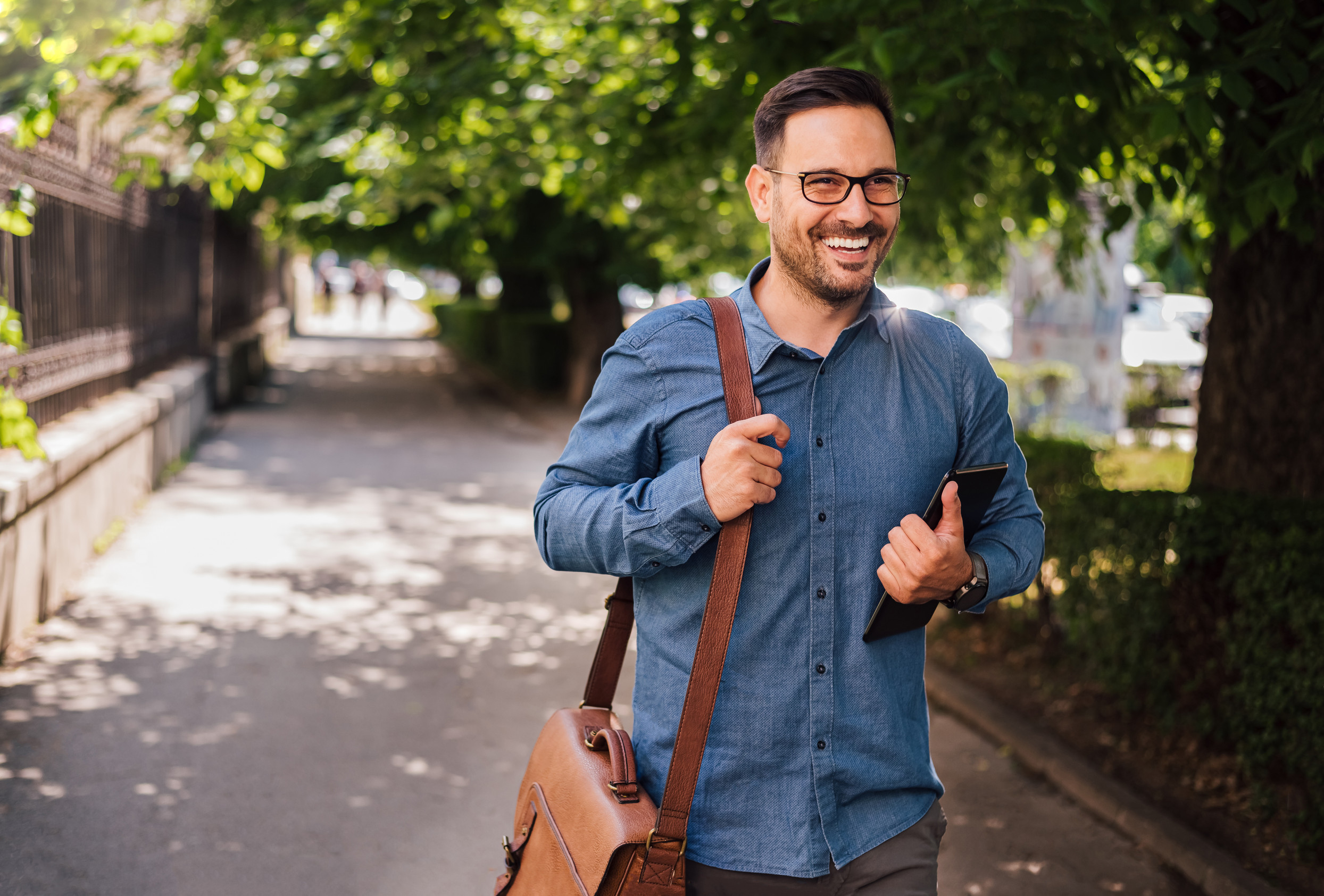 Man happily walking down sidewalk