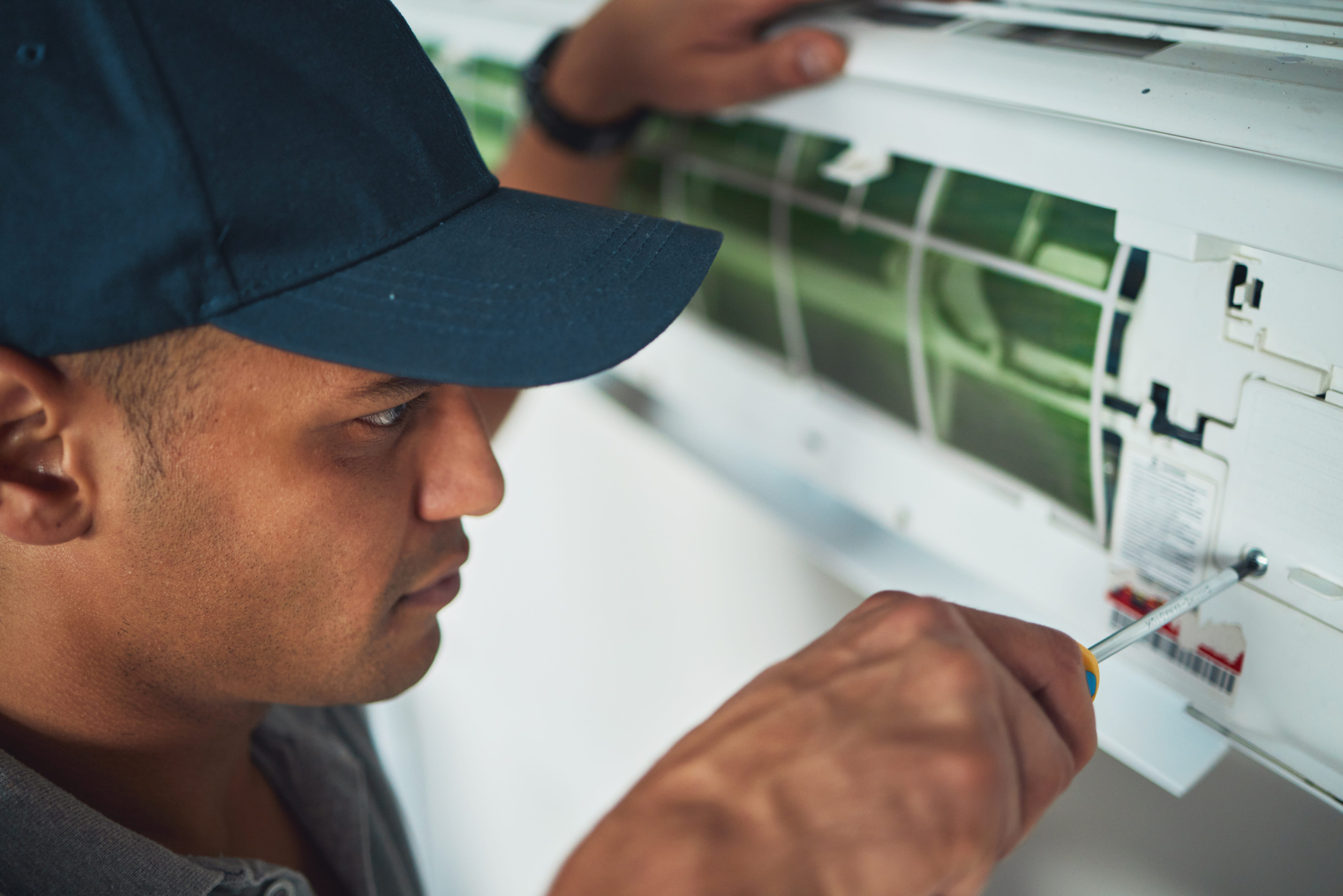 Technician performing HVAC maintenance in Virginia