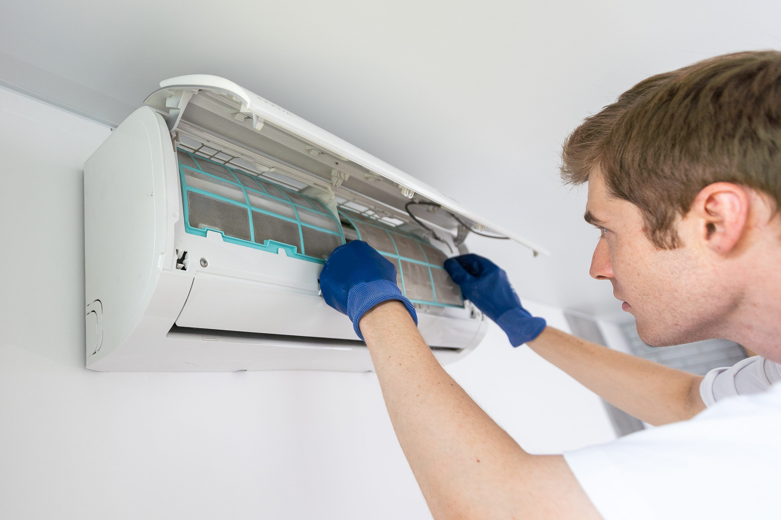 Technician performing HVAC maintenance in Virginia