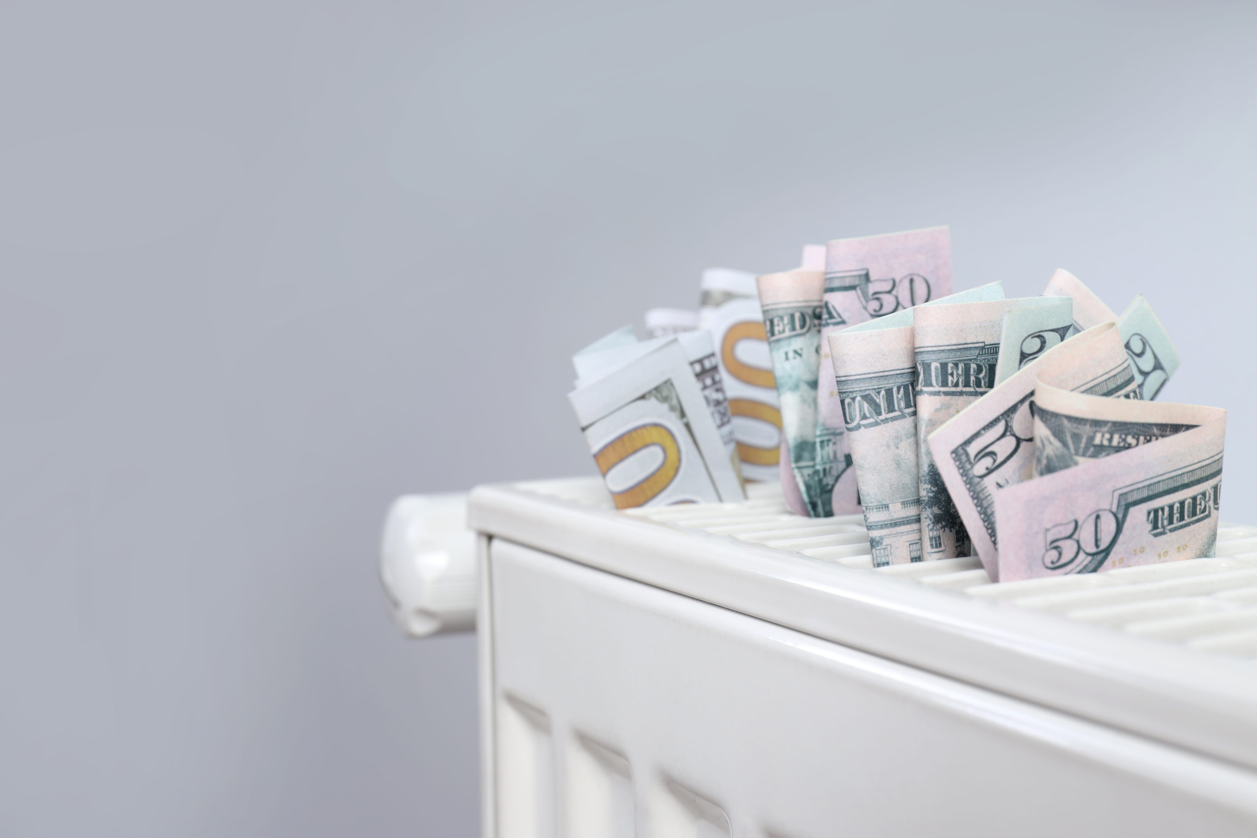 Dollar bills tucked into an HVAC system